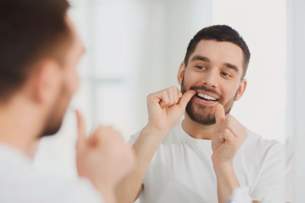 man flossing